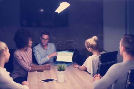 Photo for Multiethnic startup business team in night office - Royalty Free Image