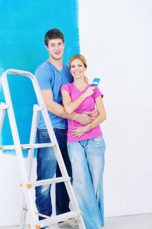 Foto de Joven pareja pintura pared en nuevo hogar - Imagen libre de derechos