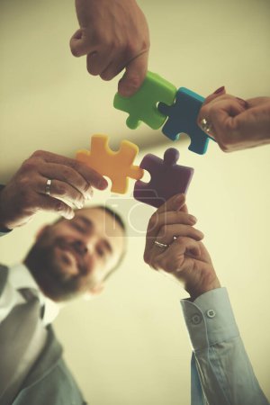 Photo for Business people group assembling jigsaw puzzle - Royalty Free Image