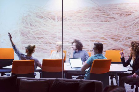Téléchargez les photos : Startup Business Team à une réunion dans un immeuble de bureaux de nuit moderne - en image libre de droit