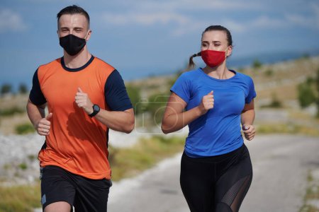 Photo for Couple running in nature wearing mask - Royalty Free Image