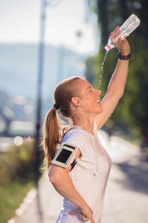 Foto de Mujer beber agua después de correr - Imagen libre de derechos