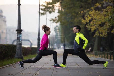 Photo for Couple warming up before jogging - Royalty Free Image
