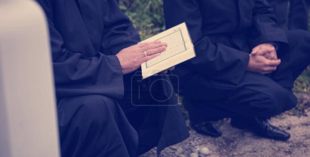 Photo for Reading of quran holy book by imam on islamic funeral - Royalty Free Image
