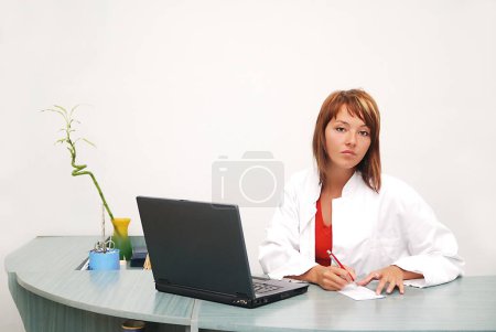 Photo for "Smilling nurse with laptop in hospital - Royalty Free Image