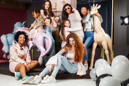 Foto de Lifestyle and people concept: young pretty diversity nations woman with different age children celebrating on birth day party together happy smiling, making selfie. African-american, Asian and Caucasian - Imagen libre de derechos