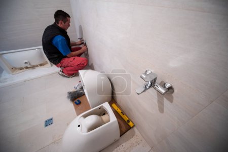 Photo for Professional plumber working in a bathroom - Royalty Free Image