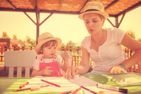 Photo for Mom and little daughter drawing a colorful pictures - Royalty Free Image