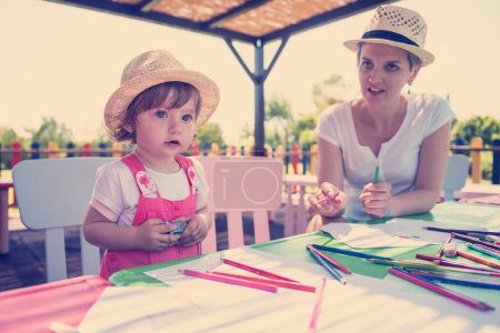 Photo for Mom and little daughter drawing a colorful pictures - Royalty Free Image