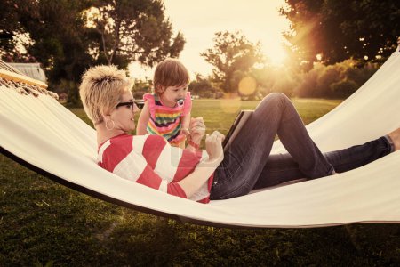 Photo for Mom and a little daughter relaxing in a hammock - Royalty Free Image