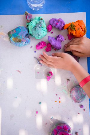 Photo for Kid hands Playing with Colorful Clay - Royalty Free Image