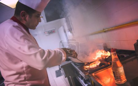 Téléchargez les photos : "Chef faisant flambe sur la nourriture
" - en image libre de droit