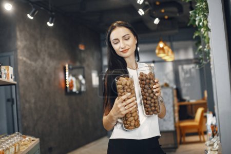 Photo for "Beautiful girl with nuts in her hands." - Royalty Free Image