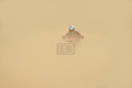 Photo for Motocross biker riding in the sandy dust - Royalty Free Image