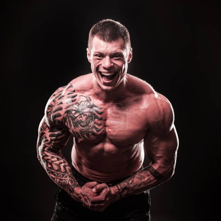 Photo for "portrait of a cheerful muscular male bodybuilder" - Royalty Free Image
