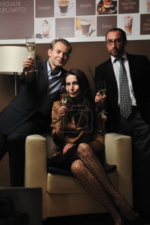 Photo for Portrait of three people holding champagne glasses and enjoying party - Royalty Free Image
