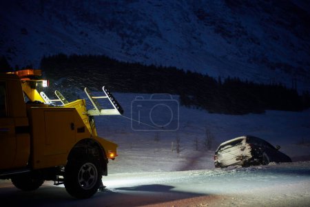 Photo for Car being towed after accident in snow storm - Royalty Free Image