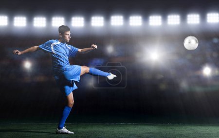 Photo for Soccer player in front of big modern stadium with flares and lights - Royalty Free Image