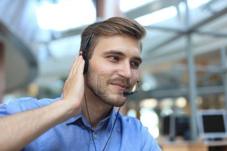 Photo for Smiling friendly handsome young male call center operator - Royalty Free Image