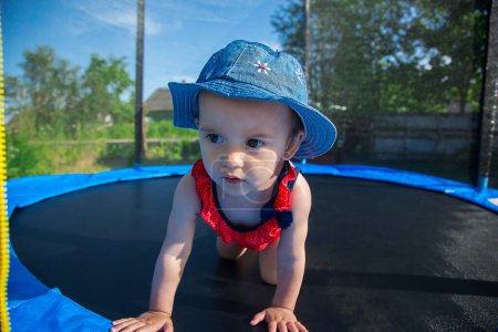 Photo for A small child posing on a trampoline - Royalty Free Image
