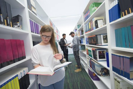 Photo for Students group  in school  library - Royalty Free Image