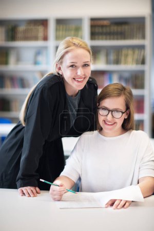 Photo for Female teacher helping students on class - Royalty Free Image