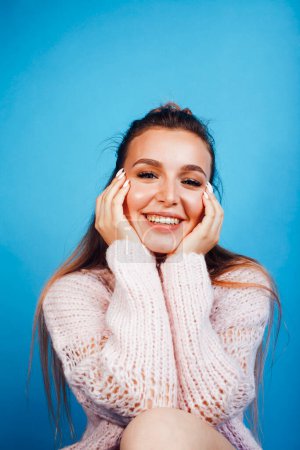 Photo for Young pretty modern hipster girl posing emotional happy on blue background, lifestyle people concept - Royalty Free Image