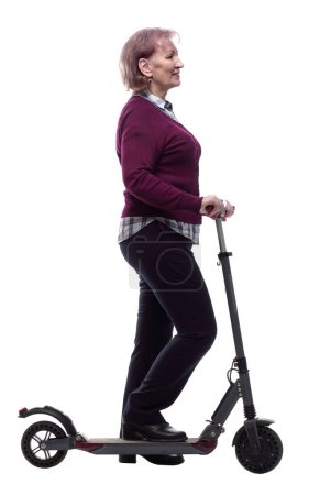 Photo for Friendly elderly woman on an electric scooter. - Royalty Free Image