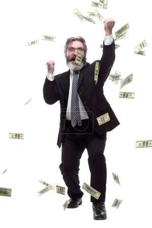 Foto de Hombre de negocios feliz bajo la lluvia de billetes. aislado en un blanco - Imagen libre de derechos