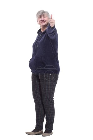 Photo for "casual elderly woman in comfortable clothing showing a thumbs up" - Royalty Free Image