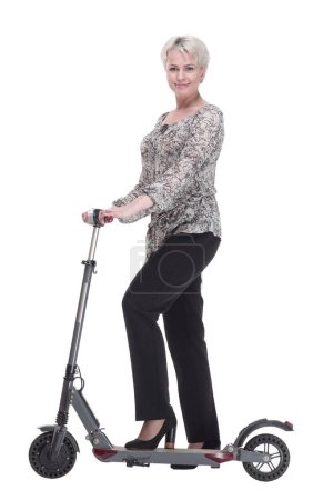 Téléchargez les photos : "side view. elegant young woman with an electric scooter looking" - en image libre de droit
