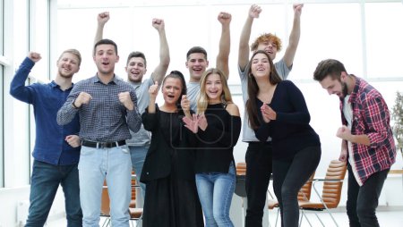 Photo for Team of happy young people standing in a new office - Royalty Free Image
