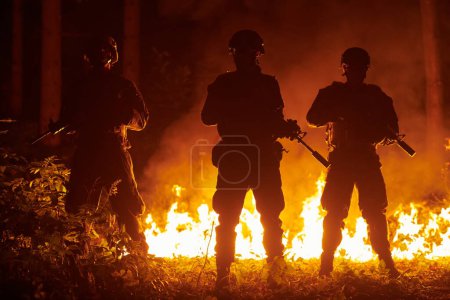 Photo for Soldiers in action with assault rifles at night - Royalty Free Image