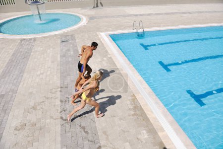 Photo for Happy young family have fun in swimming pool - Royalty Free Image