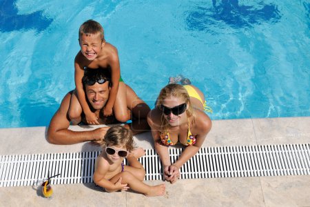 Photo for Happy young family have fun in swimming pool - Royalty Free Image