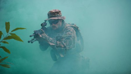 Photo for Soldier in action aiming on weapon using laser sight optics - Royalty Free Image