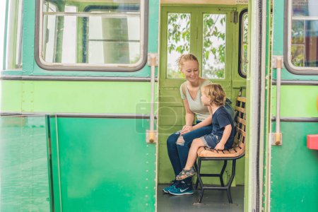 Foto de Mamá e hijo van a ir en un viejo tranvía. Viajar con niños en concepto de Hong Kong - Imagen libre de derechos