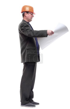 Photo for Side view. man with a roll of drawings looking at you. - Royalty Free Image