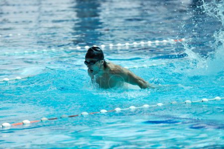 Photo for Male athlete is swimming in swim pool - Royalty Free Image