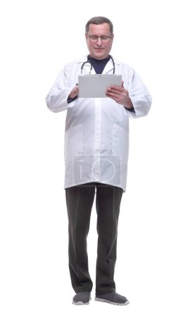 Photo for In full growth. doctor looking at the screen of a digital tablet - Royalty Free Image