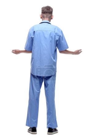 Foto de Vista trasera. paramédico en uniforme azul leyendo un anuncio en un blanco - Imagen libre de derechos