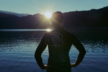 Photo for Triathlon athlete starting swimming training on lake - Royalty Free Image