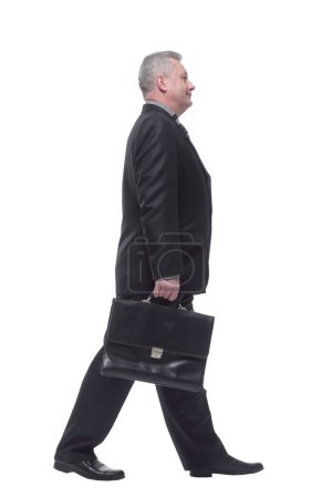 Photo for "Side view business man walking with briefcase" - Royalty Free Image