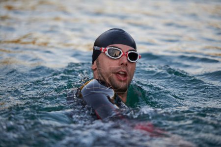 Photo for Triathlete swimmer having a break during hard training - Royalty Free Image