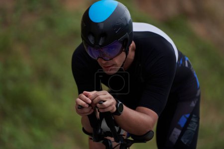 Photo for Triathlon athlete riding a bike wearing black - Royalty Free Image