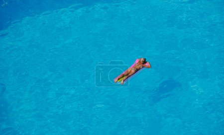 Photo for Woman relax at swimming pool - Royalty Free Image