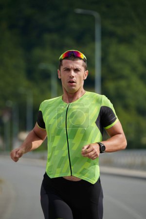 Photo for Triathlon athlete running on street - Royalty Free Image