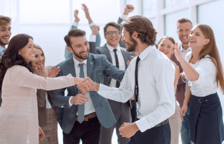 happy group of employees congratulating their leader