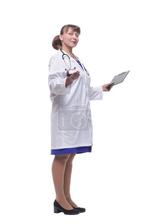 Foto de Hermosa doctora sosteniendo portapapeles sonriendo aislada sobre fondo blanco
. - Imagen libre de derechos