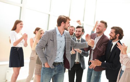 Photo for "young business man accepting congratulations from his colleagues" - Royalty Free Image